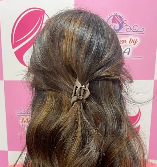 After: long brown hair with soft caramel balayage, seen from behind.
