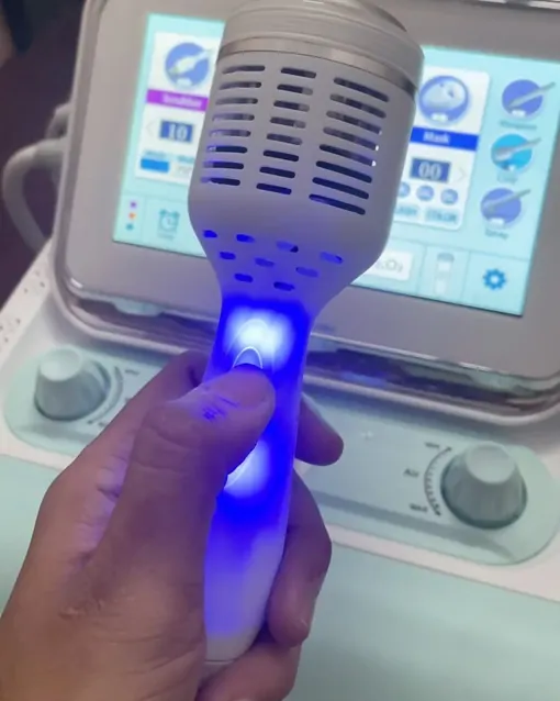 The Hydra Facial machine at the salon, its hand tool lit blue.