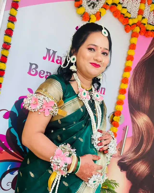 Baby shower look: a green saree with fresh-flower jewellery for dohale jevan.